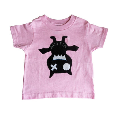 Pink Hanging Bat kids shirt by Sky Blue Milo, featuring a playful bat design, hanging on a display hanger for toddlers.