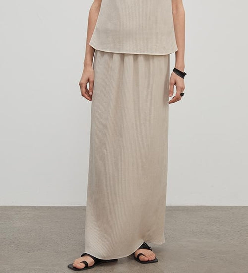 Brown Coeus high-density silk luxury skirt for women, flowing and elegant, shown above the clouds in a stylish fashion image.