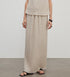 Brown Coeus high-density silk luxury skirt for women, flowing and elegant, shown above the clouds in a stylish fashion image.
