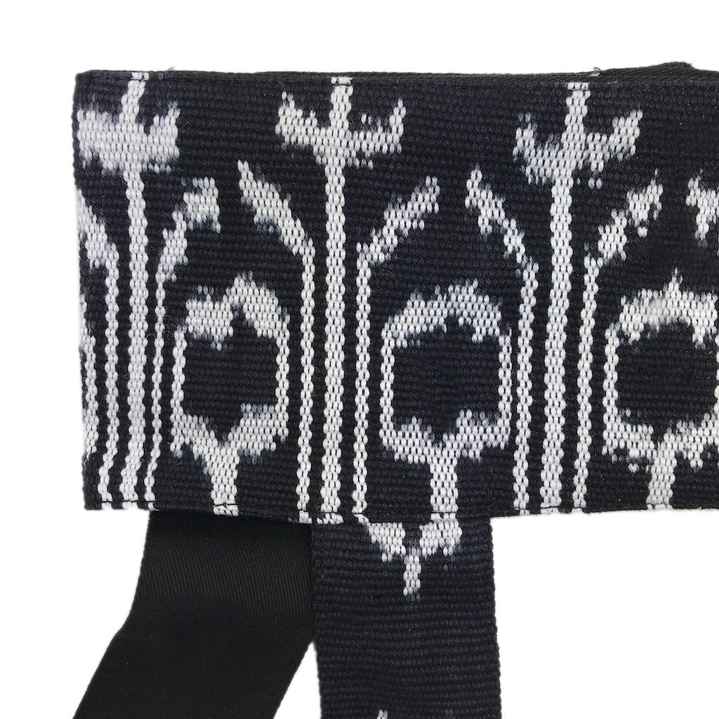 Ariel backstrap yoga mat sling with ikat pattern, designed for carrying and storing yoga mats and accessories.