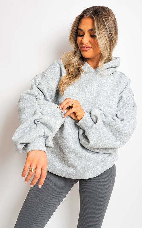 Women’s oversized fall winter hoodie with ruched sleeves from Raspberry Coconut, cozy and stylish women’s clothing.