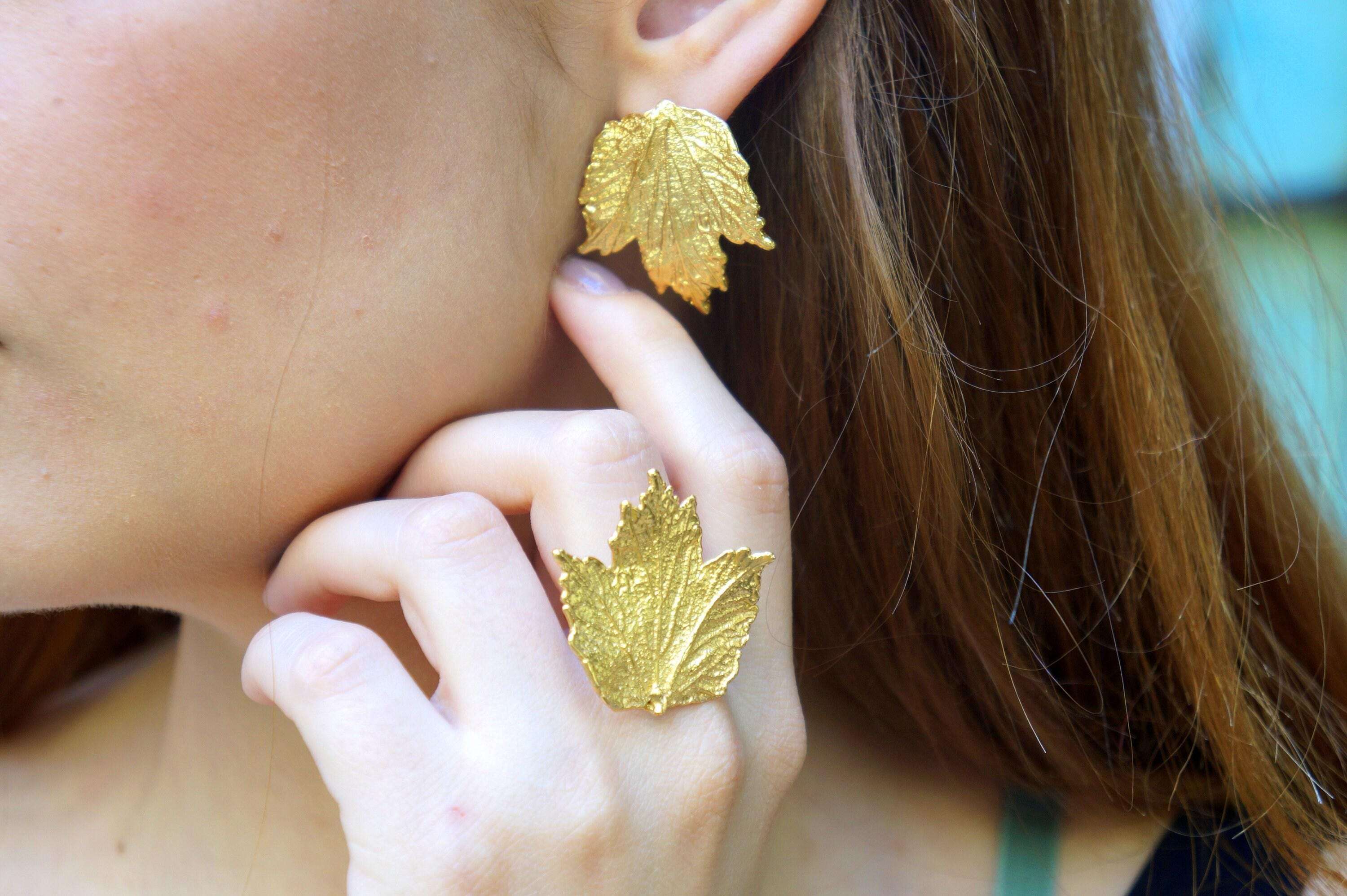 Beige Briseis Bourbon Rose Leaf Ring in gold-plated brass, adjustable jewelry with detailed rose leaf design.
