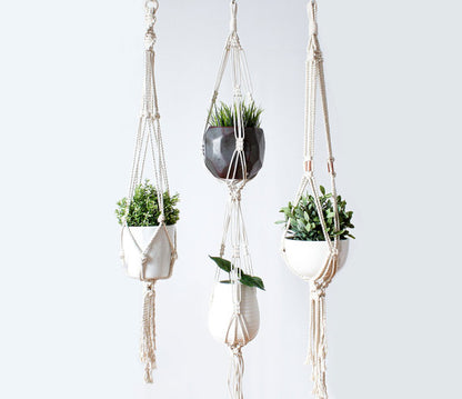 Silver Simba macrame plant hanger for indoor and outdoor use, featuring intricate knotted design and space for potted plants.