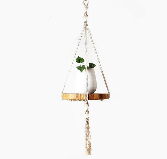 Silver Simba macrame plant hanger with intricate knots, holding a potted plant for home and garden decor.
