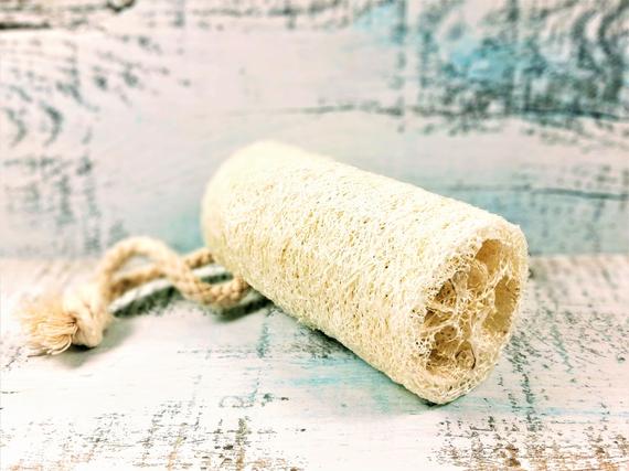 Organic natural 4-inch yellow Shadow loofah sponge for bathroom exfoliation, vegan luffa for gentle skin cleansing.