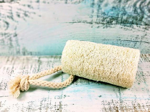 Organic natural 4-inch loofah sponge from Yellow Shadow, ideal for vegan bathroom exfoliation and skincare.