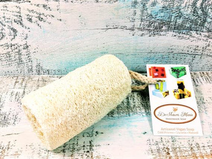 Organic natural 4-inch loofah from Yellow Shadow, showing textured, fibrous vegan bathroom exfoliating sponge.