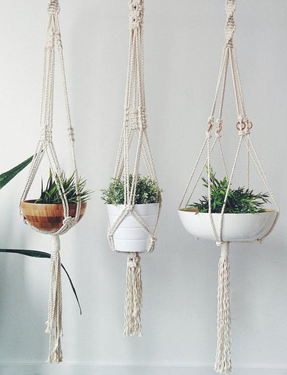 Silver Simba macrame plant hanger for home and garden, featuring intricate knotted design and space for hanging potted plants.