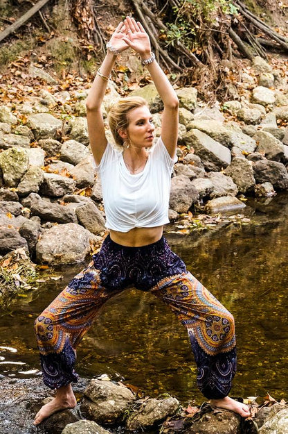 Purple psychedelic boho pants for women by Tan Smokey, featuring vibrant hippie-style yoga pants with colorful patterns.