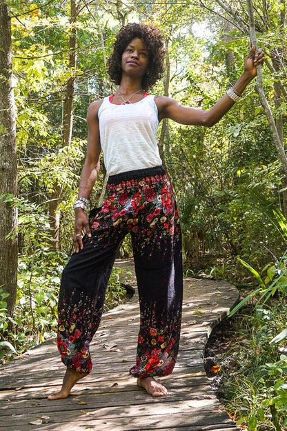 Black floral boho yoga pants for women by Tan Smokey, featuring a relaxed fit and vibrant floral pattern.