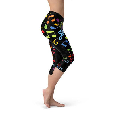 Colorful music notes pattern Capri leggings for women by Maroon Sooty, shown on a model with a close-up view of the vibrant design.
