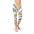 White marble-patterned Capri leggings by Maroon Sooty with black gold line accents, showcasing a stylish and comfortable athletic wear design.