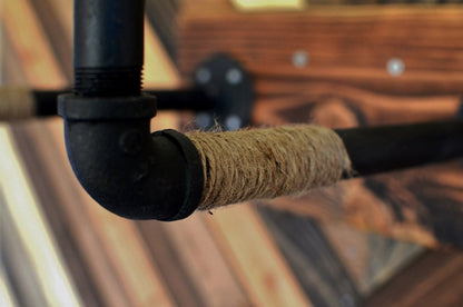Burlap Iron Pipe Bicycle wall display from Pinwheel, perfect for home and garden decor, featuring rustic bicycle design on burlap background.