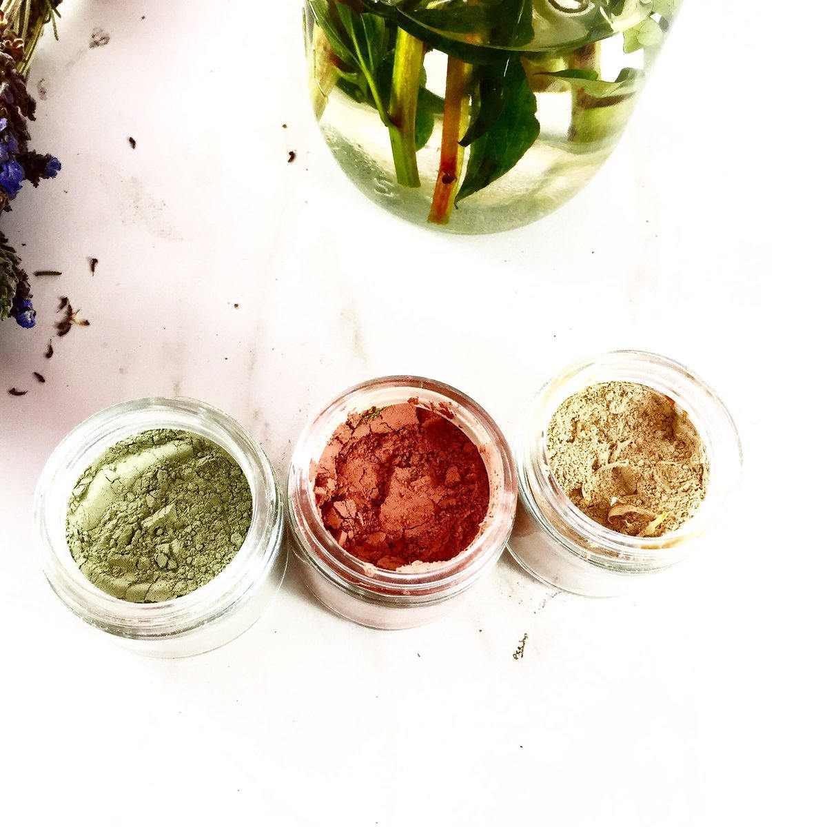 White Smokey clay face mask trio with rose, French green, and kaolin clays alongside turmeric for skincare, shown in the image.