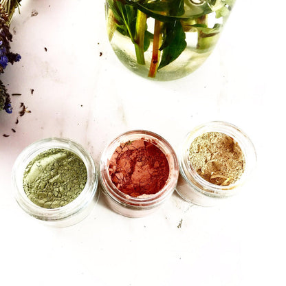 White Smokey clay face mask trio with rose, French green, and kaolin clays alongside turmeric for skincare, shown in the image.