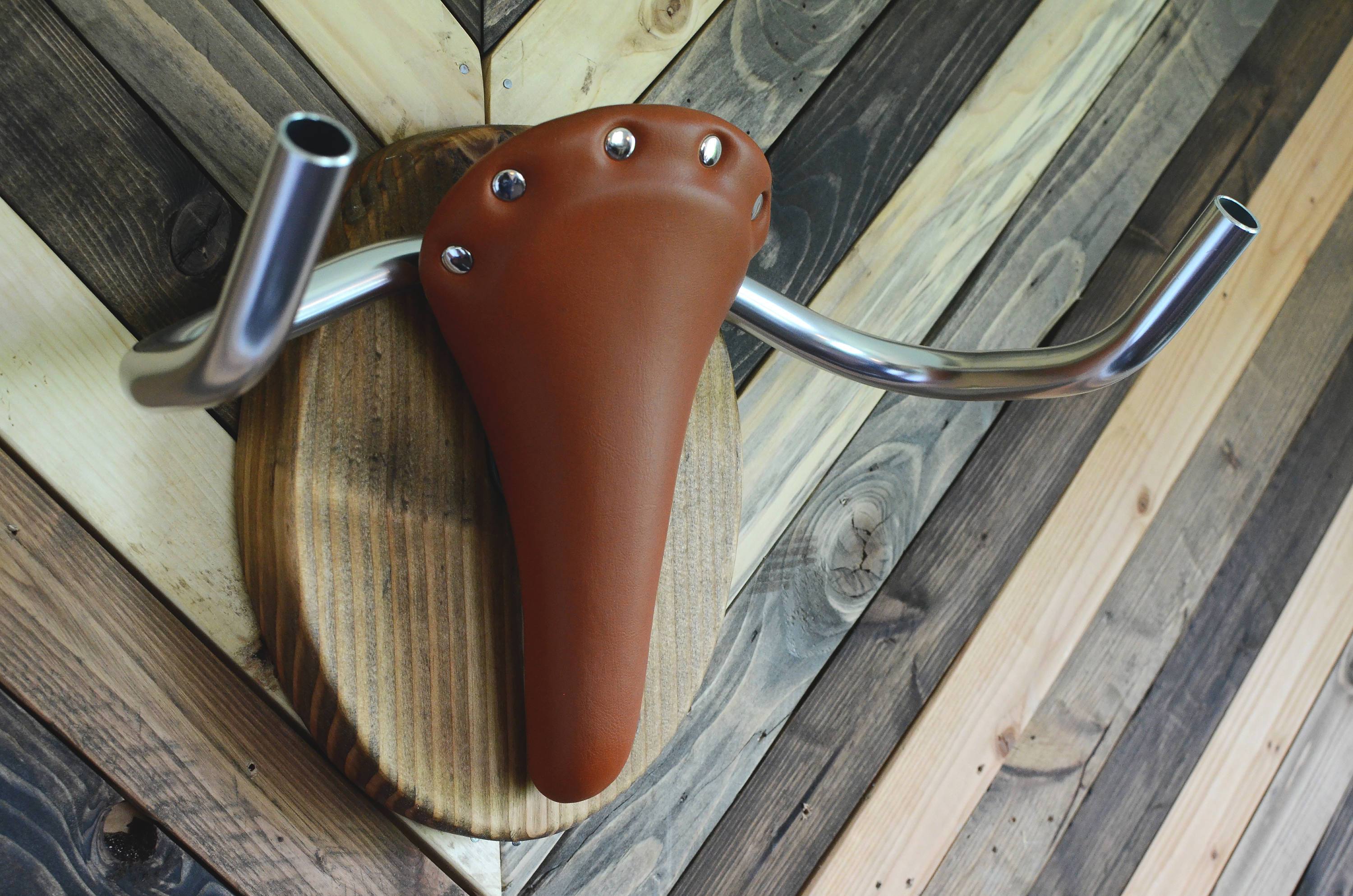 Decorative bike rack featuring a longhorn steer taxidermy design by Pinwheel, suitable for home and garden decor.