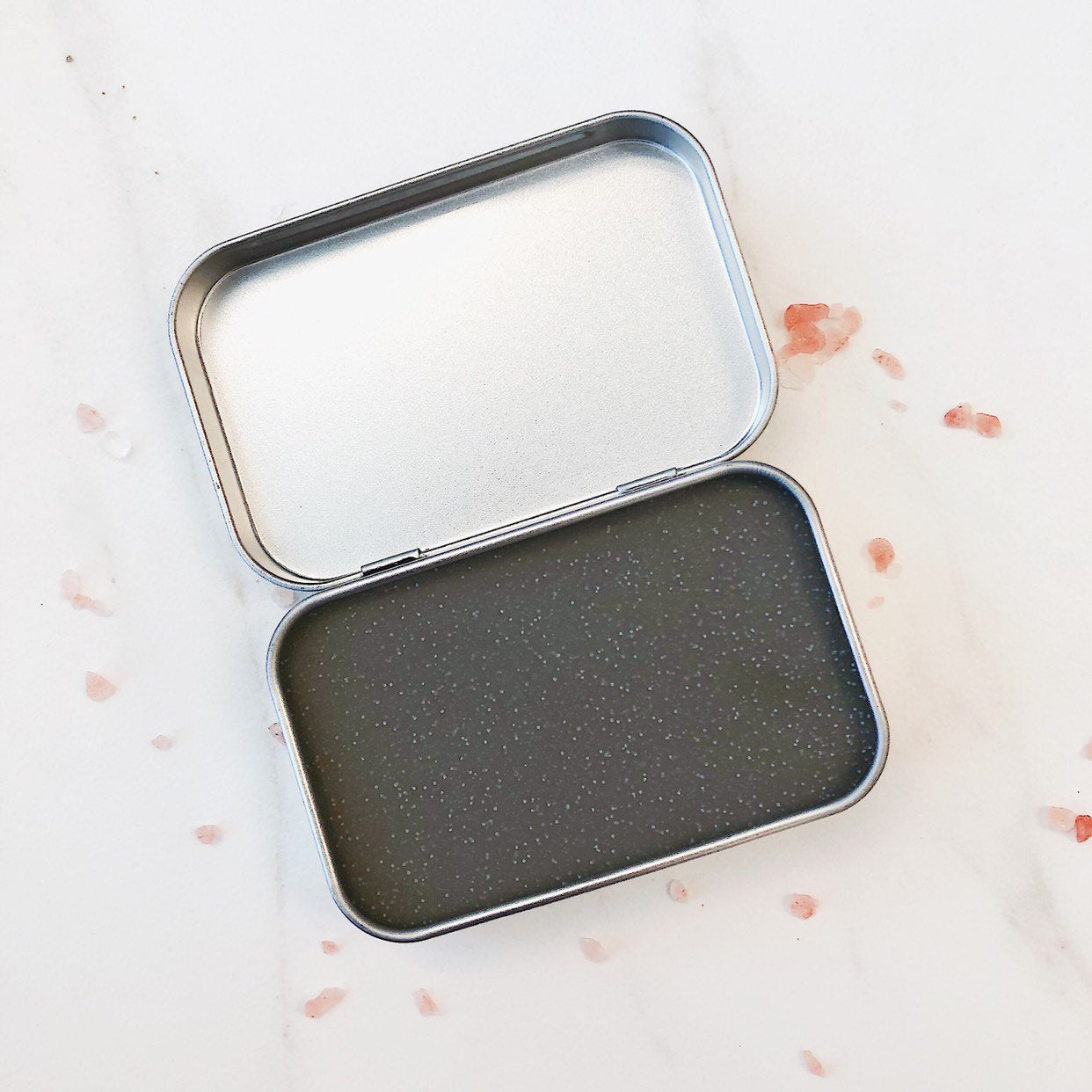 White Smokey organic pomade hair wax styling gel in a jar, demonstrating a natural, matte finish for textured hair styling.