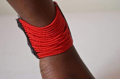 Colorful Maasai African beaded spiral cuff bracelet by White Baobab, showcasing intricate beadwork on a flexible metal band.