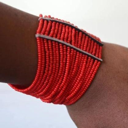 Colorful Maasai African beaded spiral cuff bracelet by White Baobab, featuring intricate beadwork and vibrant patterns on a flexible design.