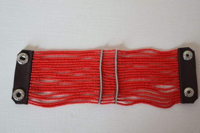 White Baobab Maasai African beaded cuff spiral bracelet with colorful intricate beadwork on a white background.