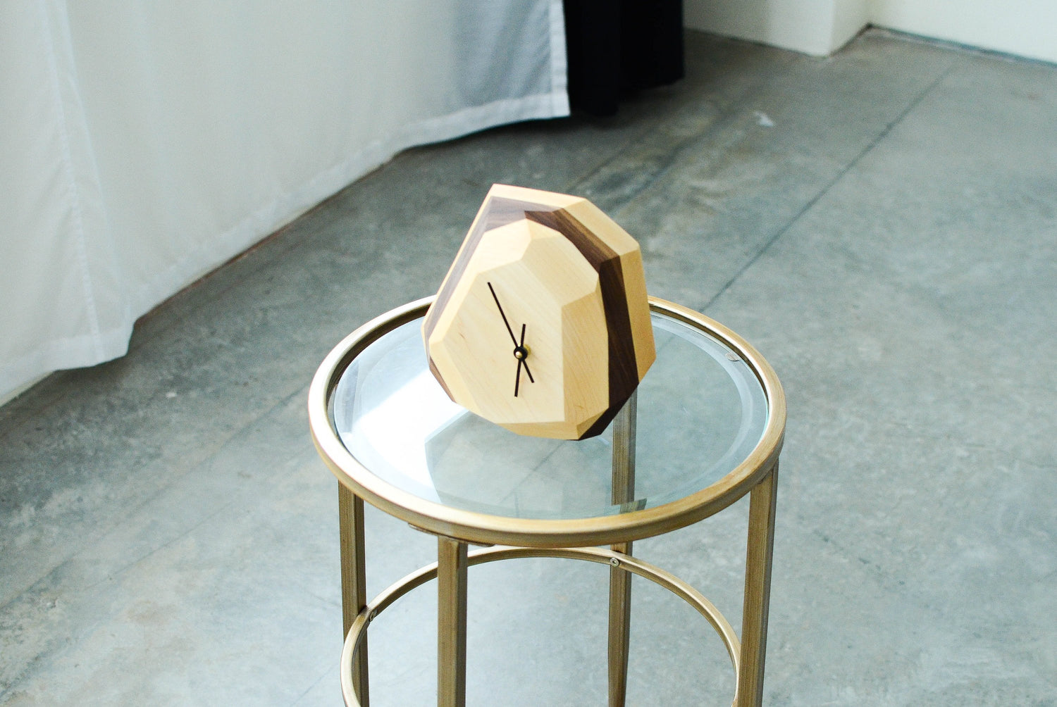 Pinwheel geometric wall and table clock with modern design, featuring bold shapes and a sleek finish for stylish home decor.