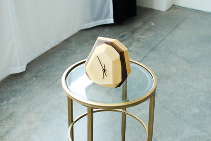 Pinwheel geometric wall and table clock with modern design, featuring bold shapes and a sleek finish for stylish home decor.
