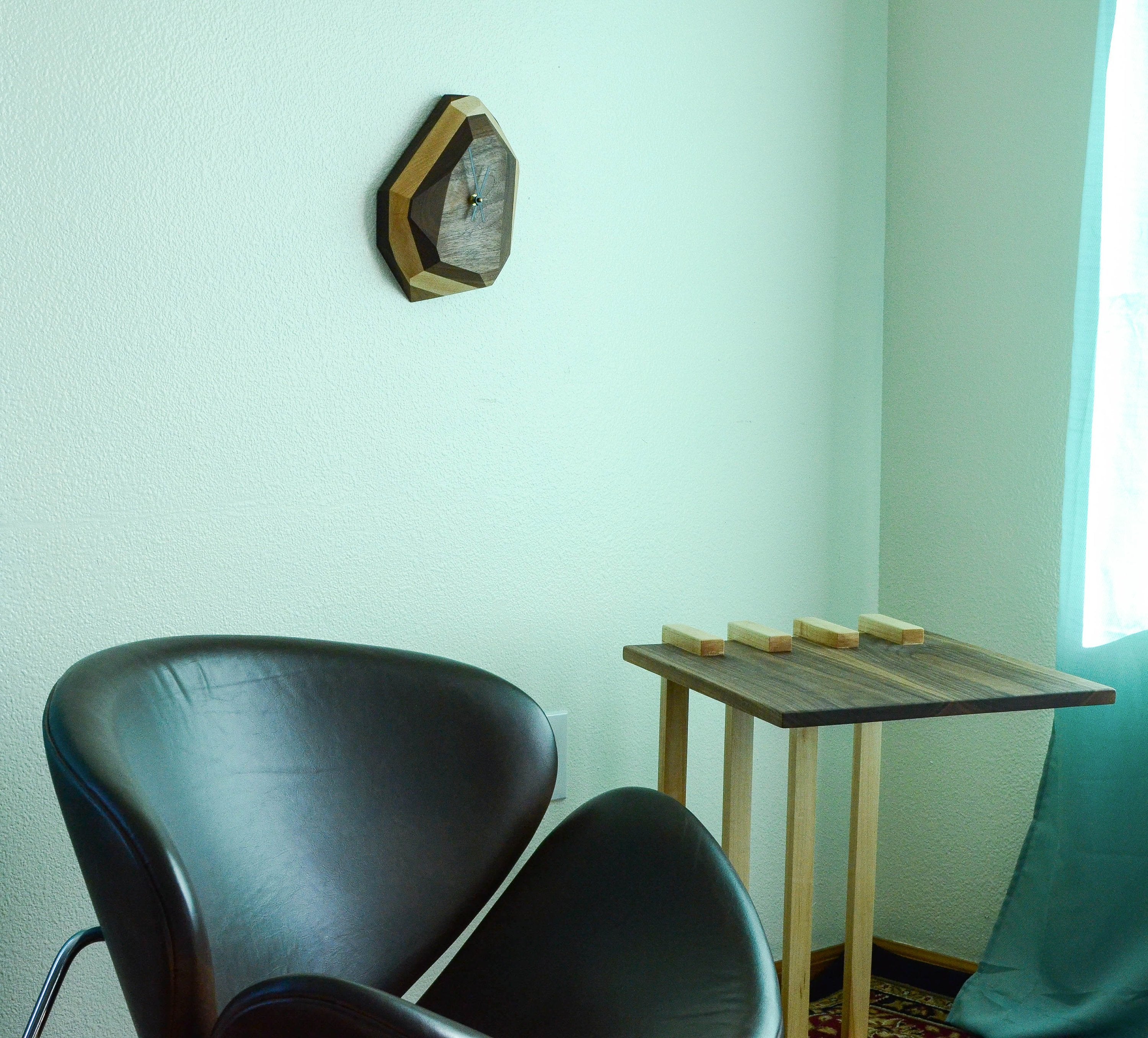 Pinwheel geometric wall and table clock with modern design, featuring bold shapes and a stylish home decor accent.