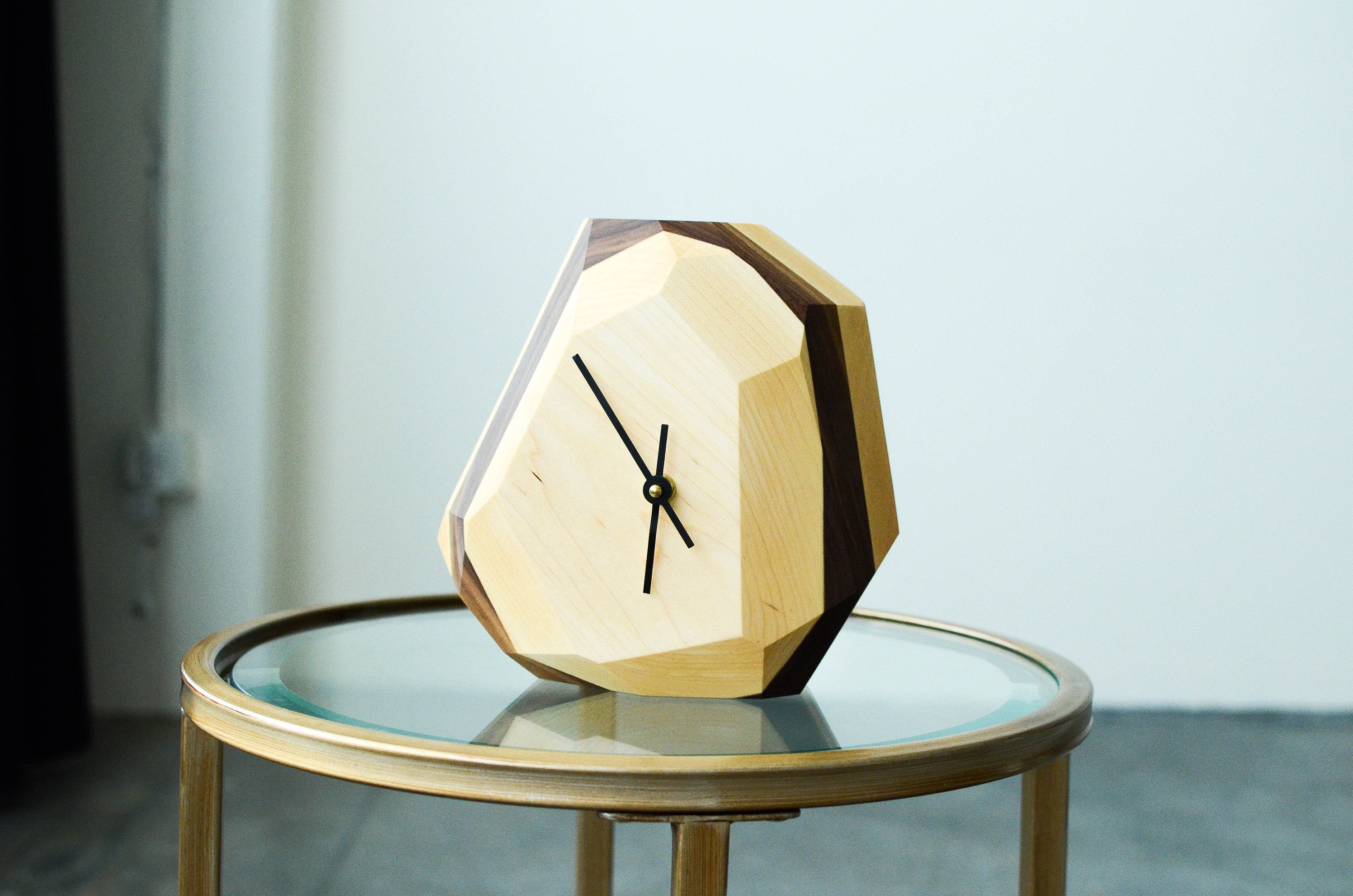Pinwheel geometric wall and table clock featuring a modern, minimalist design with black and white geometric patterns.
