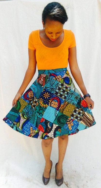 White Baobab Kitenge round women’s mini wrap skirt with colorful African print fabric, styled with a fitted waist.