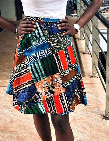 Vintage Batik wrap mini Kitenge skirt with African round design, styled with a White Baobab T-shirt in a vibrant, colorful fabric pattern.