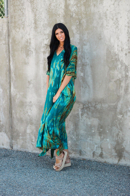 Teal green tie-dyed plus size kaftan dress with pockets by Erin Pontus, flowing fabric with relaxed fit and vibrant pattern.