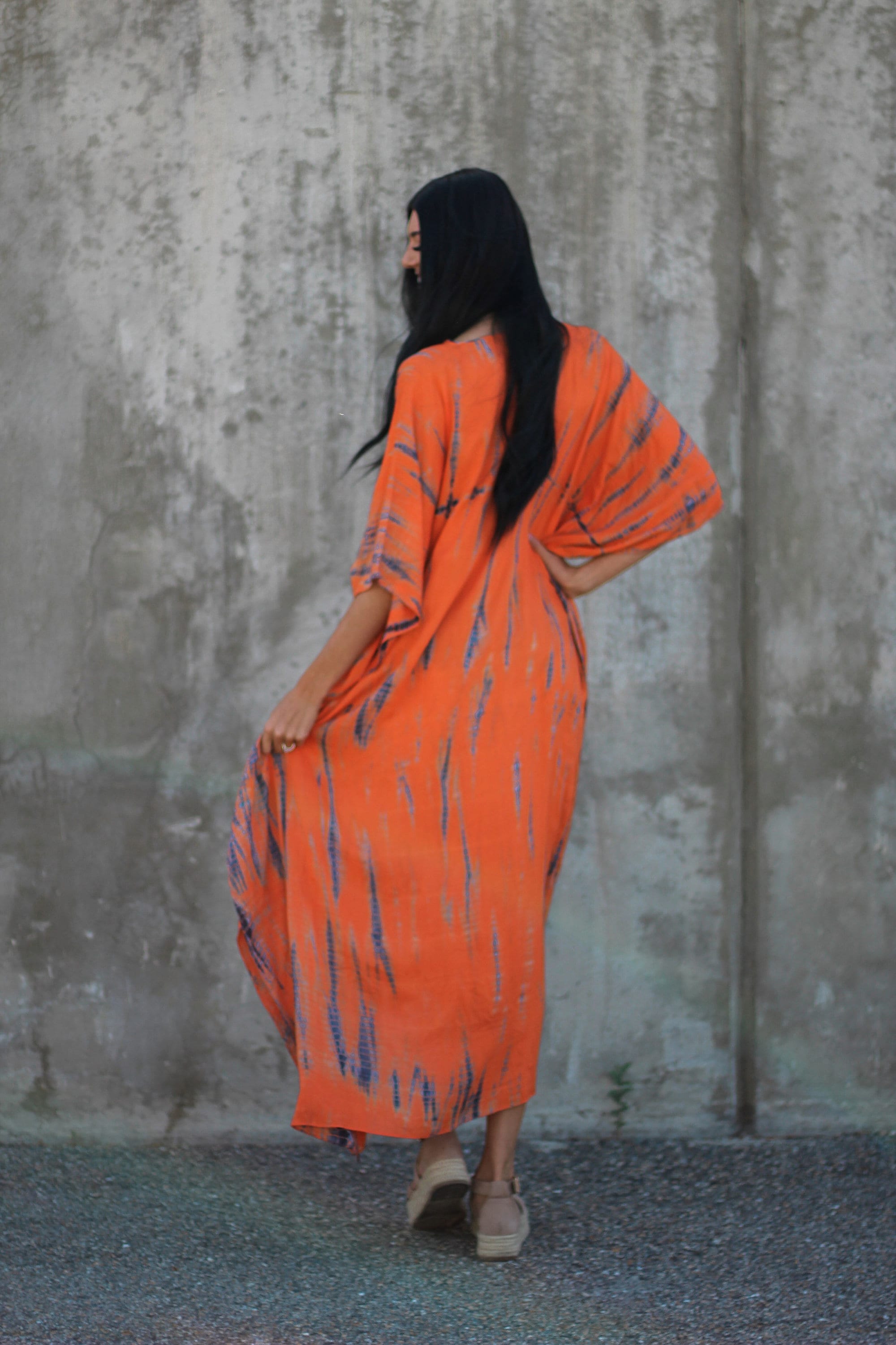 Hand-dyed orange tie-dye maxi kaftan dress by Erin Pontus featuring pockets and a loose fit, perfect for casual summer wear.