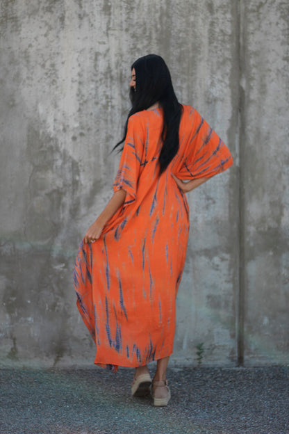 Hand-dyed orange tie-dye maxi kaftan dress by Erin Pontus featuring pockets and a loose fit, perfect for casual summer wear.