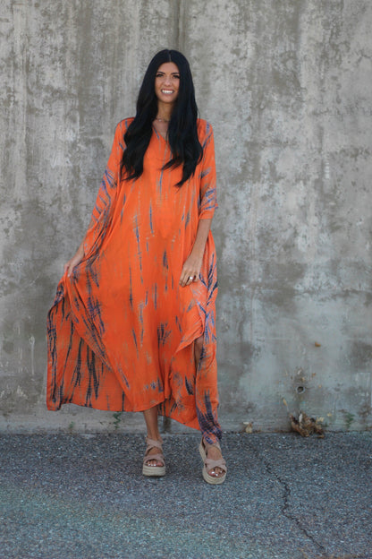 Orange tie-dye maxi kaftan dress by Erin Pontus with pockets, loose fit, hand-dyed, perfect for casual or beach wear.