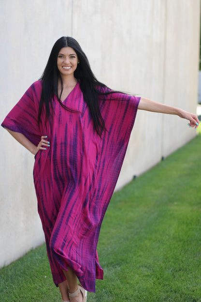 Plus size tie-dyed kaftan dress by Erin Pontus featuring vibrant African and Indian-inspired patterns and flowing fabric.