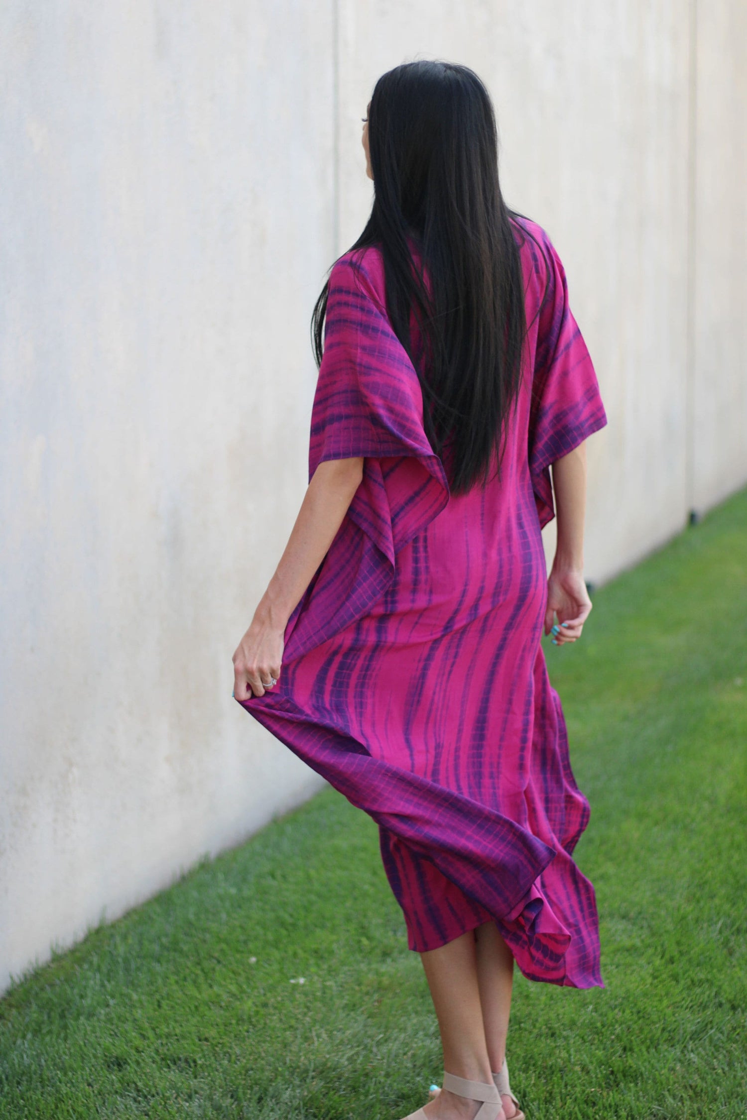 Plus size tie-dyed African and Indian kaftan dress by Erin Pontus, featuring vibrant colors and flowing fabric.