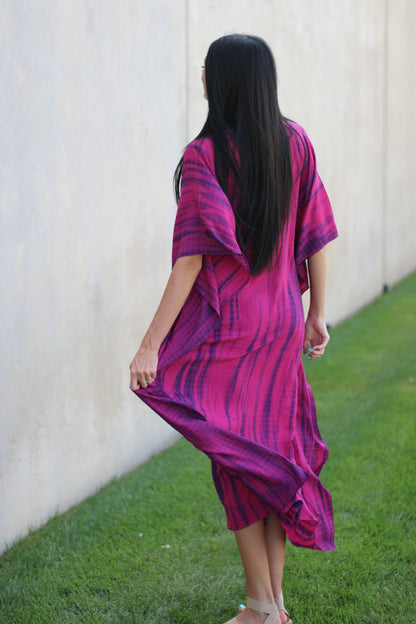 Plus size tie-dyed African and Indian kaftan dress by Erin Pontus, featuring vibrant colors and flowing fabric.