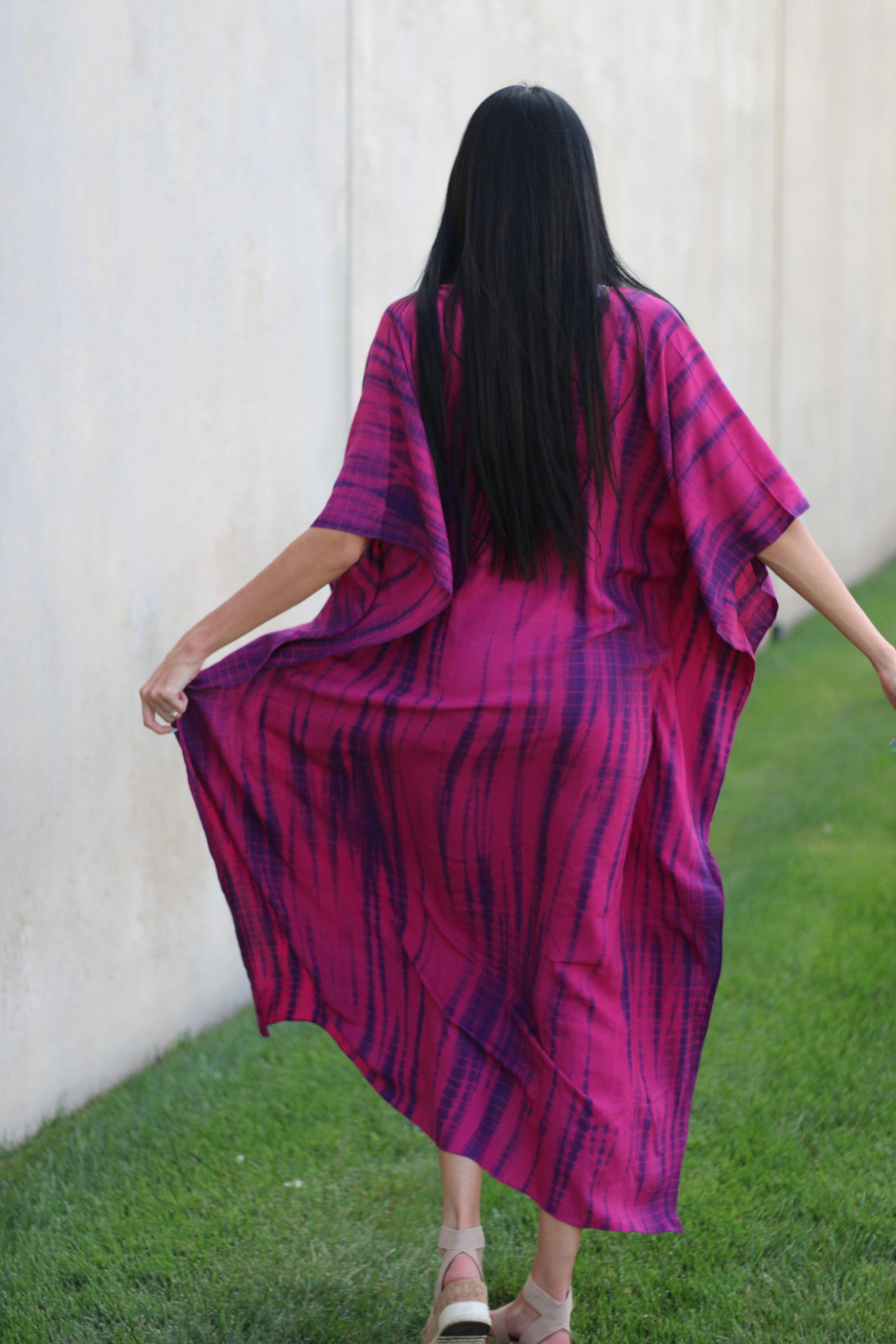 Plus size tie-dyed kaftan dress by Erin Pontus featuring vibrant African and Indian-inspired patterns and flowing fabric.