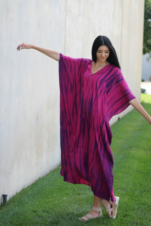 Plus size tie-dyed kaftan dress by Erin Pontus featuring vibrant African and Indian-inspired patterns and flowing fabric.