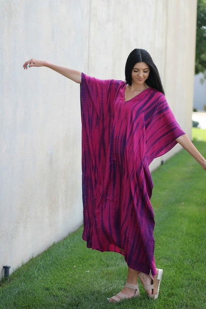 Plus size tie-dyed kaftan dress by Erin Pontus featuring vibrant African and Indian-inspired patterns and flowing fabric.