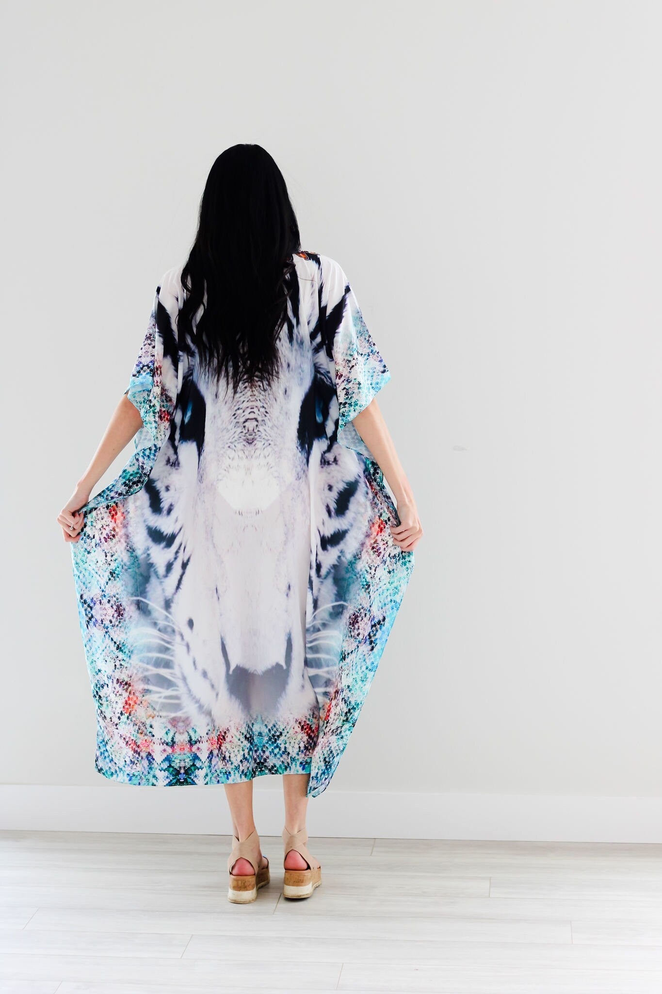 Plus size tribal embroidered kaftan dress by Erin Pontus featuring intricate embellishments and flowing fabric.