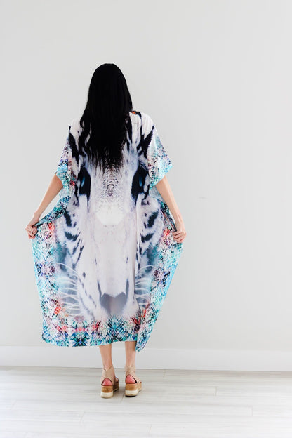 Plus size tribal embroidered kaftan dress by Erin Pontus featuring intricate embellishments and flowing fabric.