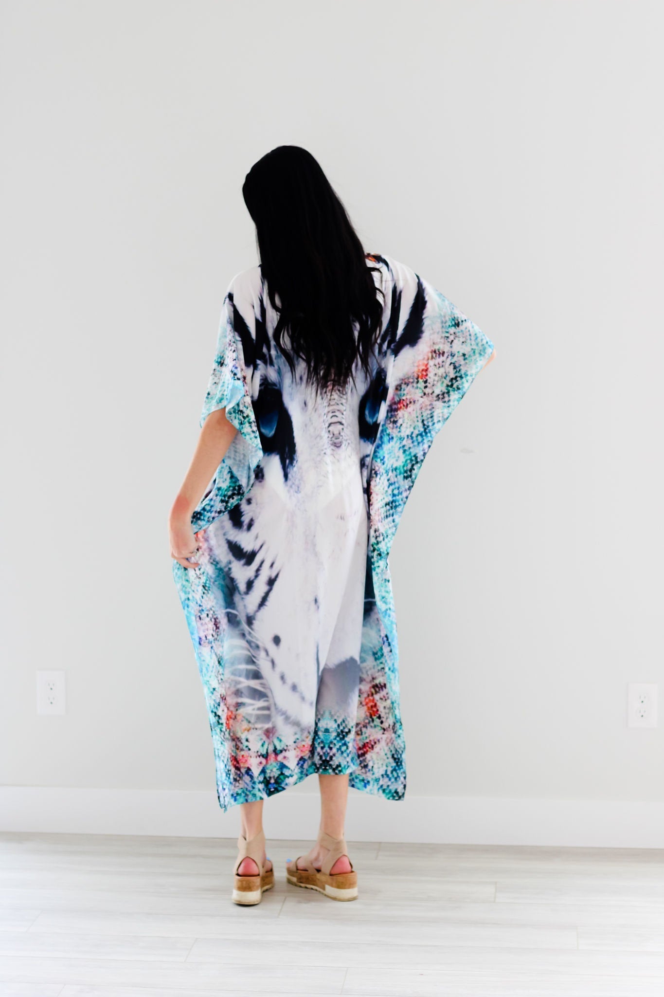 Plus size tribal kaftan dress by Erin Pontus, featuring intricate embellishments and flowing fabric, perfect for elegant resort wear.