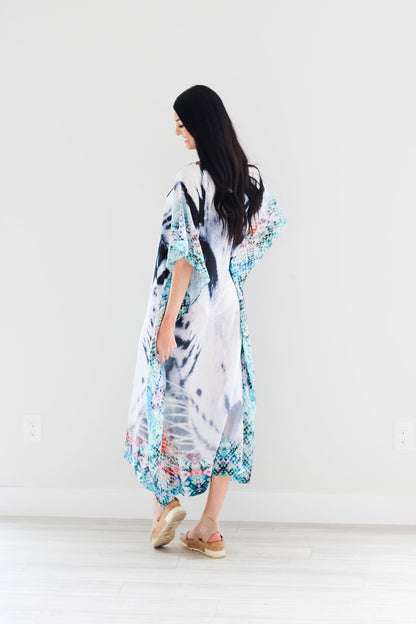 Plus size tribal-inspired embroidered kaftan dress by Erin Pontus featuring intricate embellishments and flowing fabric.