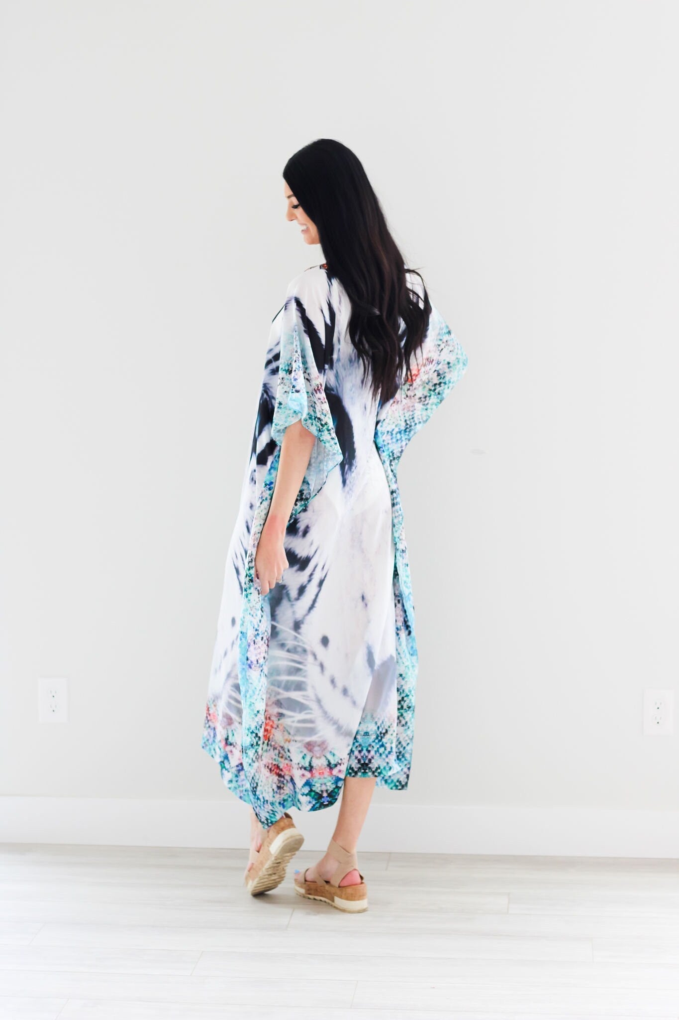 Plus size tribal embellished kaftan dress by Erin Pontus, featuring intricate embroidery and flowing fabric, suitable for elegant occasions.