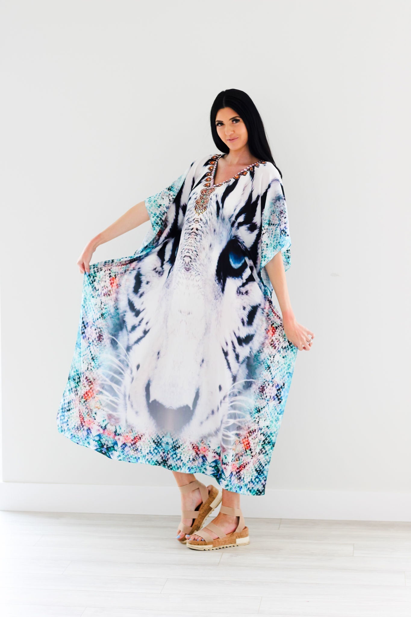 Plus size tribal kaftan dress by Erin Pontus featuring intricate embellishments and flowing fabric, ideal for stylish summer wear.
