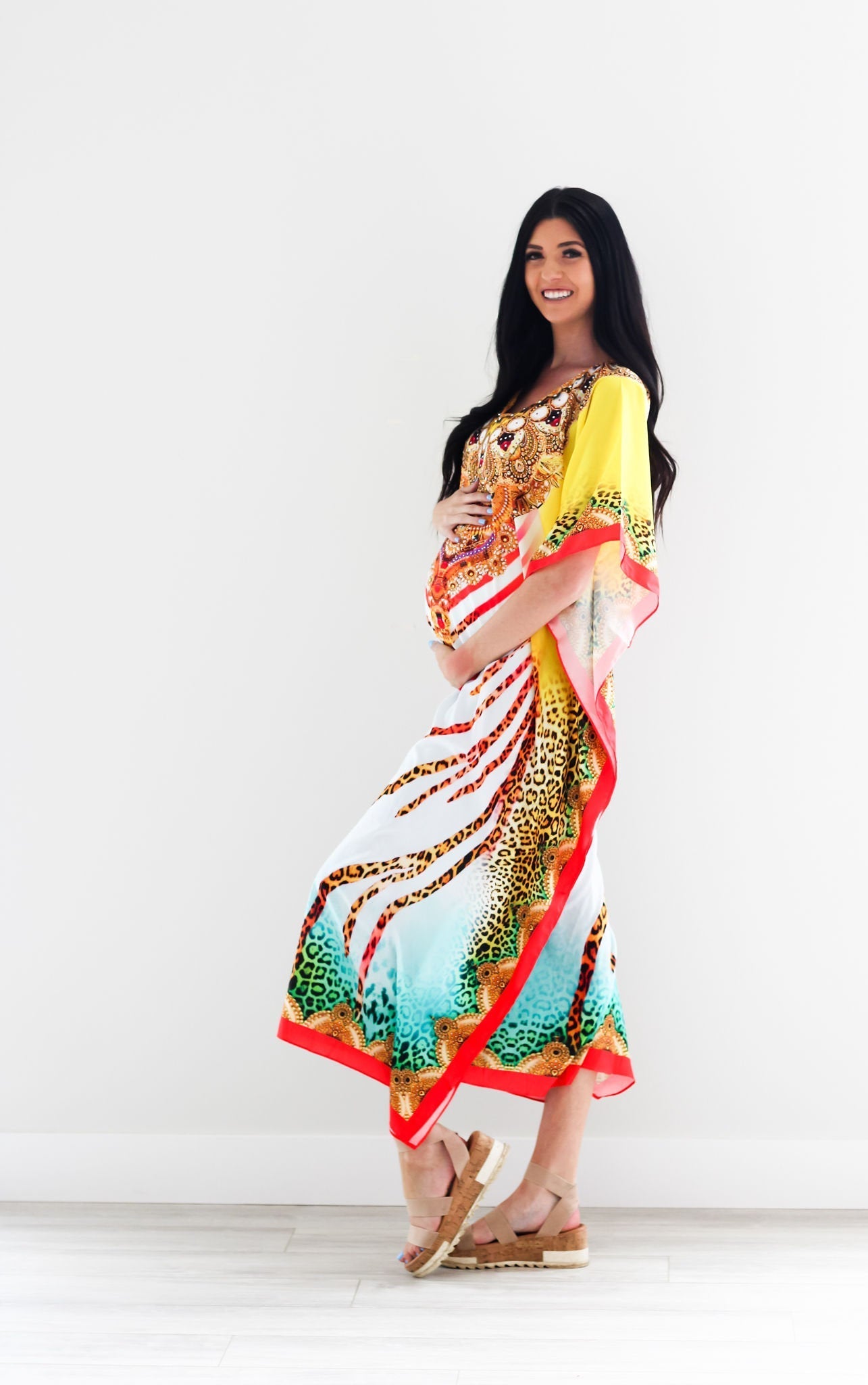 Traditional tribal kaftan dress by Erin Pontus featuring vibrant African-inspired patterns and flowing gypsy-style design.