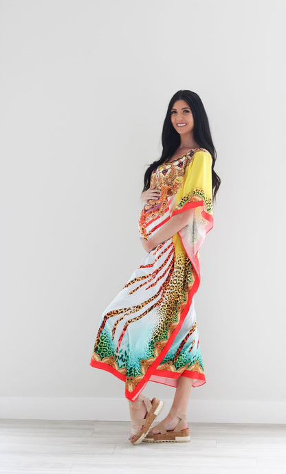 Colorful traditional tribal kaftan dress by Erin Pontus featuring intricate African-inspired patterns and flowing fabric.