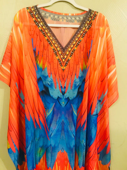 Plus size tribal feather kaftan dress by Erin Pontus, flowing bohemian style with intricate patterns and vibrant fabric details.