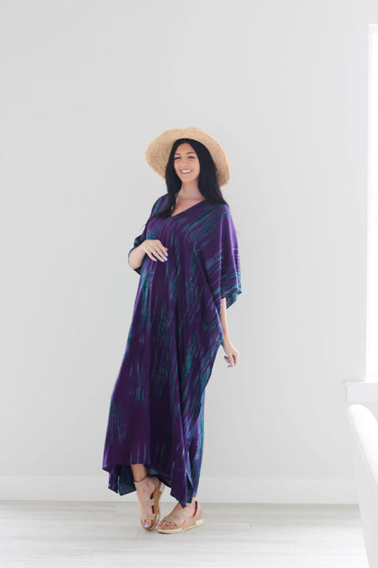 Purple tie-dyed maxi dress by Erin Pontus featuring a flowing kaftan style and long sleeves, perfect for elegant wear.